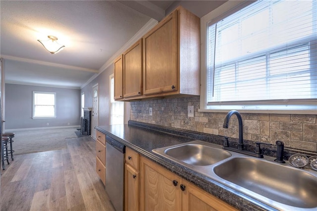 904 E 84th St, Kansas City, MO 64131 - kitchen featuring light wood finished floors, ornamental molding, dark countertops, stainless steel dishwasher, and decorative backsplash