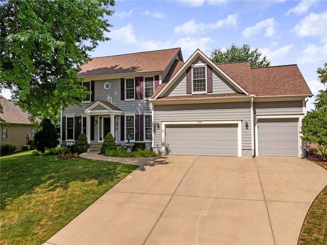 508 Ambersham Dr, Lees Summit, MO 64081 - colonial home featuring a front yard, concrete driveway, a garage, and roof with shingles