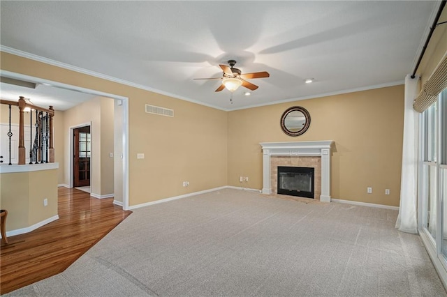 508 Ambersham Dr, Lees Summit, MO 64081 - unfurnished living room with carpet floors, ceiling fan, a tile fireplace, ornamental molding, and recessed lighting