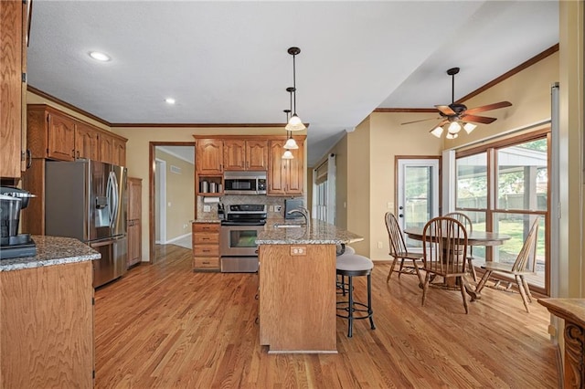 508 Ambersham Dr, Lees Summit, MO 64081 - kitchen featuring ornamental molding, stainless steel appliances, a ceiling fan, backsplash, and light wood-style flooring