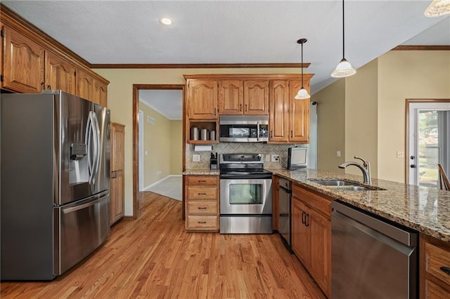 508 Ambersham Dr, Lees Summit, MO 64081 - kitchen featuring appliances with stainless steel finishes, crown molding, light wood-type flooring, light stone countertops, and backsplash
