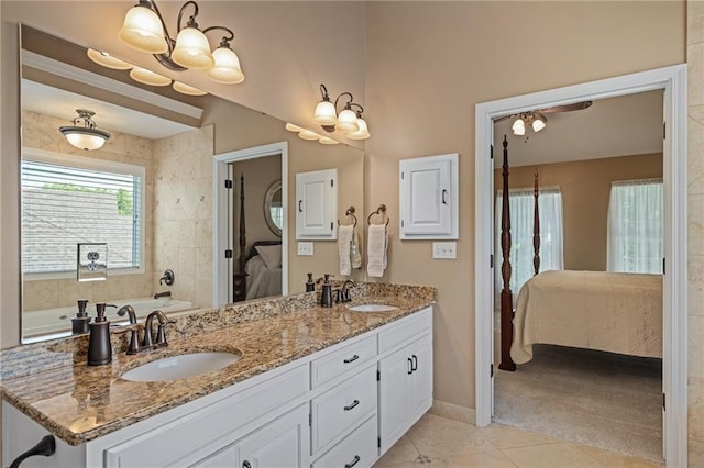 508 Ambersham Dr, Lees Summit, MO 64081 - full bathroom featuring ensuite bathroom, double vanity, tile patterned floors, a garden tub, and a chandelier