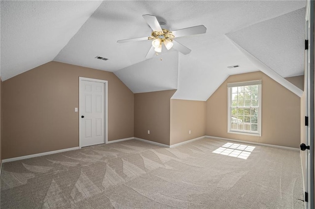 508 Ambersham Dr, Lees Summit, MO 64081 - additional living space with carpet, a textured ceiling, vaulted ceiling, and ceiling fan