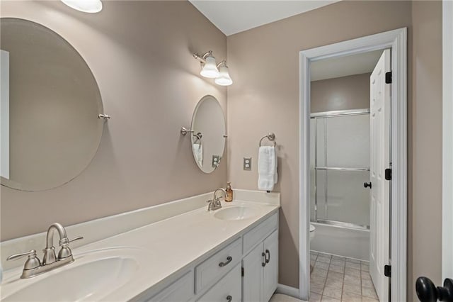 508 Ambersham Dr, Lees Summit, MO 64081 - bathroom with double vanity, bath / shower combo with glass door, and tile patterned floors