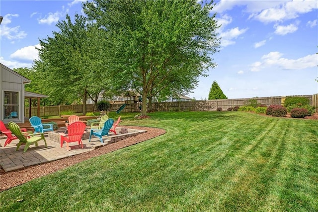 508 Ambersham Dr, Lees Summit, MO 64081 - fenced backyard with a playground, a patio area, and a fire pit