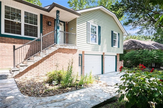 6319 Acuff St, Shawnee, KS 66216 - view of front of house with brick siding, a garage, and driveway