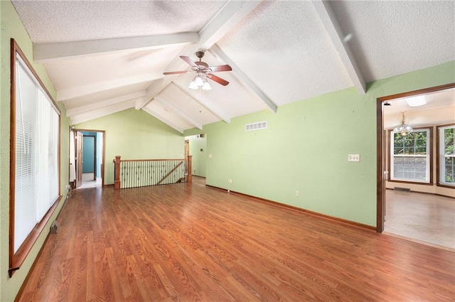 6319 Acuff St, Shawnee, KS 66216 - unfurnished living room featuring wood finished floors, a textured ceiling, and ceiling fan