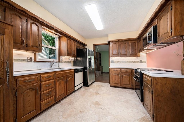6319 Acuff St, Shawnee, KS 66216 - kitchen with black gas stove, tasteful backsplash, light countertops, stainless steel microwave, and a textured ceiling