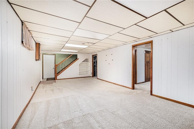 6319 Acuff St, Shawnee, KS 66216 - finished below grade area with carpet flooring, stairs, and wooden walls