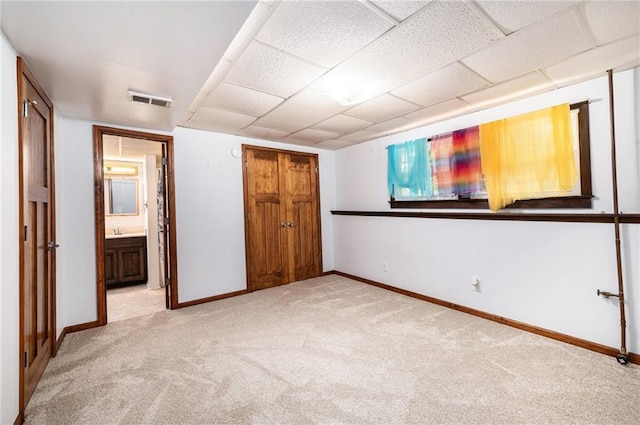6319 Acuff St, Shawnee, KS 66216 - unfurnished bedroom with light carpet, connected bathroom, and a drop ceiling
