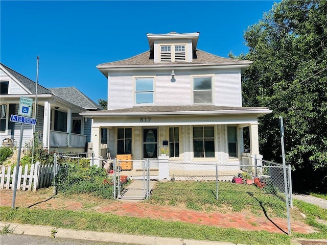 817 S 16th St, Saint Joseph, MO 64501 - traditional style home featuring a porch, a gate, a fenced front yard, and roof with shingles