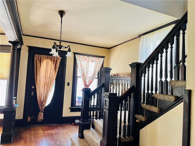 817 S 16th St, Saint Joseph, MO 64501 - foyer with hardwood / wood-style flooring, stairway, a chandelier, and ornamental molding