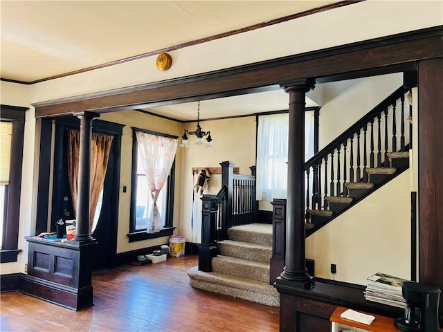 817 S 16th St, Saint Joseph, MO 64501 - foyer entrance featuring wood finished floors, crown molding, ornate columns, and plenty of natural light