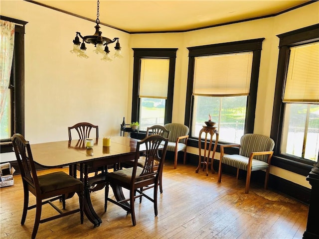 817 S 16th St, Saint Joseph, MO 64501 - dining space with a chandelier, light wood-style flooring, and ornamental molding