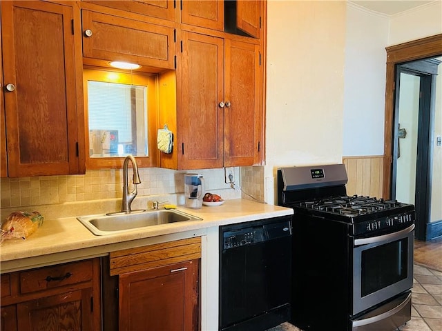 817 S 16th St, Saint Joseph, MO 64501 - kitchen featuring stainless steel gas stove, dishwasher, backsplash, light countertops, and crown molding
