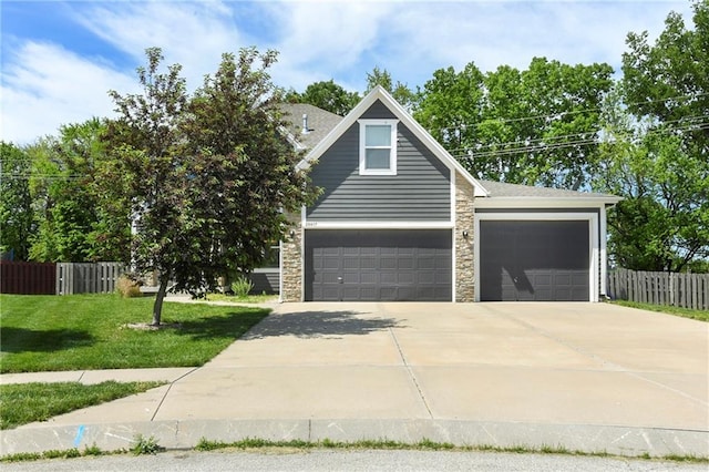 28617 W 162nd Ter, Gardner, KS 66030 - view of front of house with stone siding, concrete driveway, and an attached garage