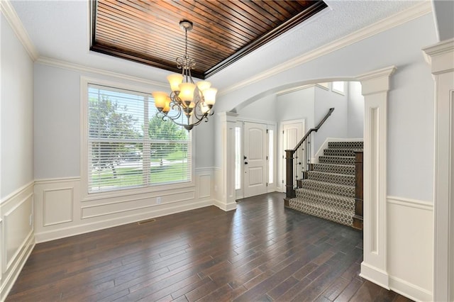 28617 W 162nd Ter, Gardner, KS 66030 - foyer featuring healthy amount of natural light, a chandelier, stairs, dark wood-style floors, and wainscoting