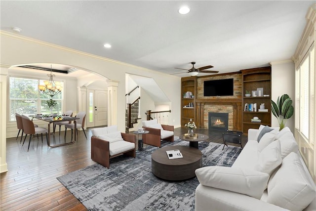 28617 W 162nd Ter, Gardner, KS 66030 - living room featuring decorative columns, arched walkways, a ceiling fan, crown molding, and plenty of natural light