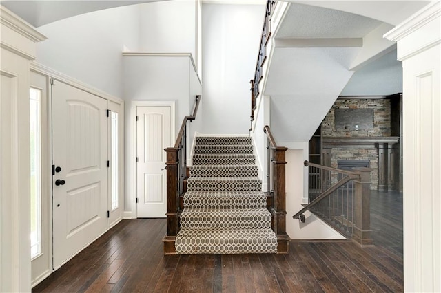 28617 W 162nd Ter, Gardner, KS 66030 - foyer entrance featuring hardwood / wood-style flooring, arched walkways, stairway, and a fireplace
