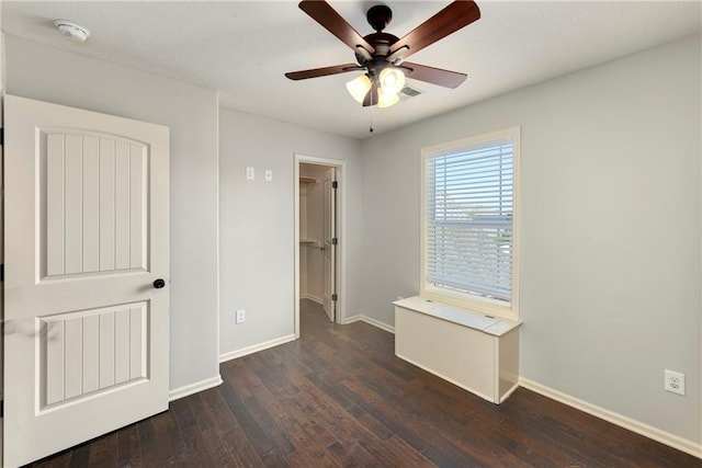 28617 W 162nd Ter, Gardner, KS 66030 - unfurnished bedroom with dark wood-type flooring, a walk in closet, and ceiling fan