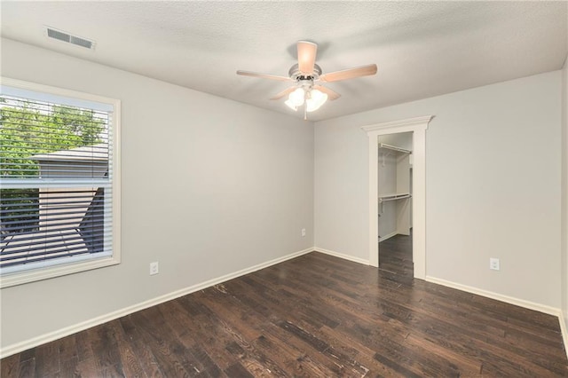 28617 W 162nd Ter, Gardner, KS 66030 - unfurnished bedroom with wood finished floors, a spacious closet, and ceiling fan