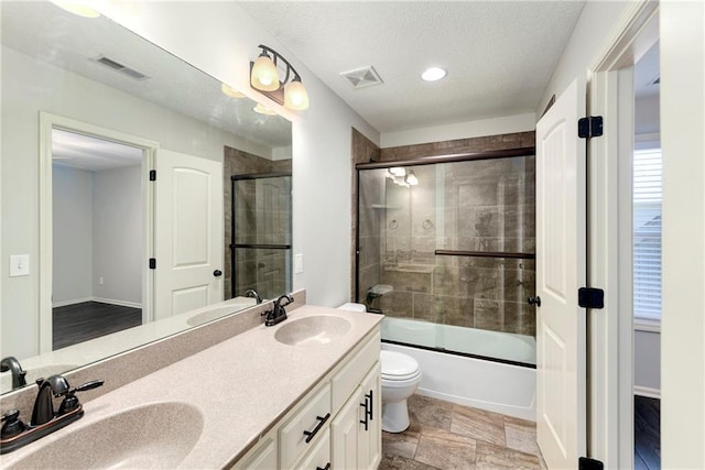 28617 W 162nd Ter, Gardner, KS 66030 - bathroom with double vanity, enclosed tub / shower combo, recessed lighting, and a textured ceiling