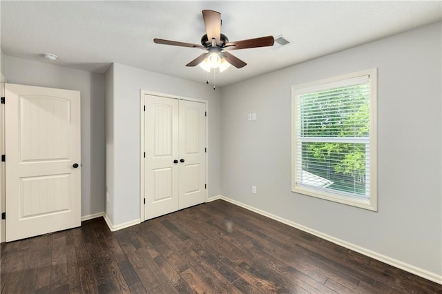 28617 W 162nd Ter, Gardner, KS 66030 - unfurnished bedroom featuring dark wood-type flooring, a closet, and ceiling fan