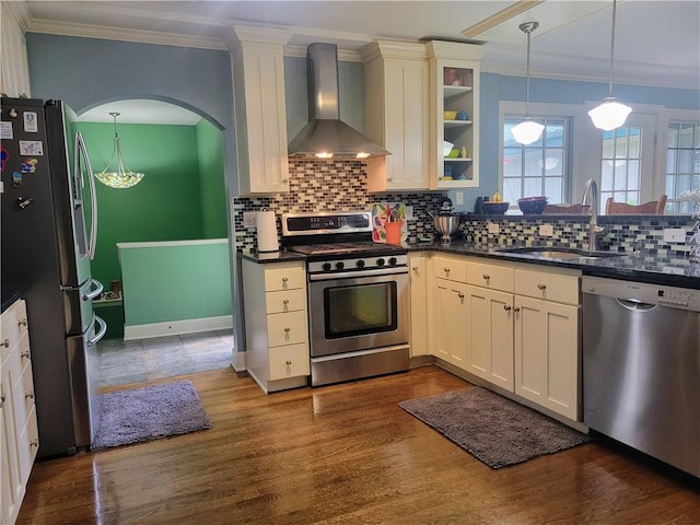 19823 74th St, Mclouth, KS 66054 - kitchen with stainless steel appliances, wall chimney exhaust hood, dark countertops, crown molding, and tasteful backsplash