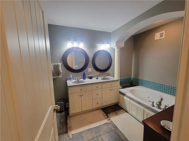 19823 74th St, Mclouth, KS 66054 - bathroom featuring double vanity, a jetted tub, and decorative columns