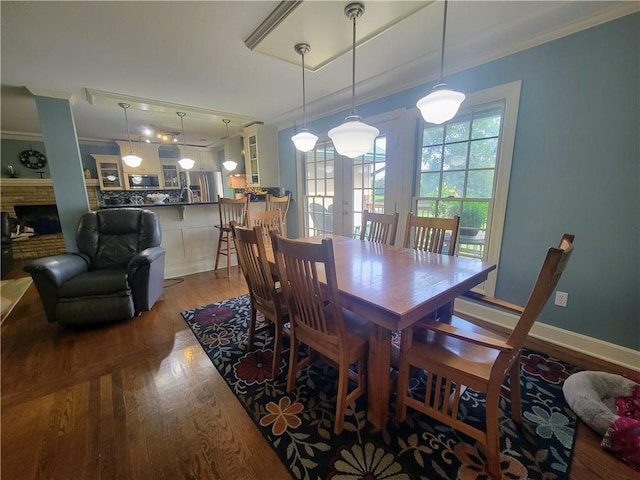 19823 74th St, Mclouth, KS 66054 - dining area featuring crown molding, light wood finished floors, and a fireplace