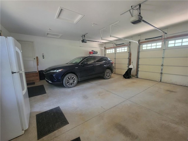19823 74th St, Mclouth, KS 66054 - garage featuring freestanding refrigerator and a garage door opener