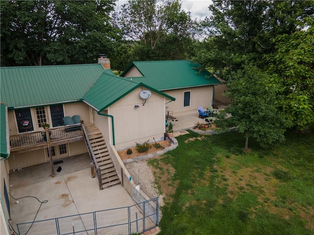 19823 74th St, Mclouth, KS 66054 - back of house featuring a patio, a metal roof, stairway, and a chimney