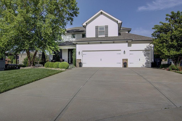 16324 S Locust St, Olathe, KS 66062 - view of front facade featuring stucco siding, a front lawn, driveway, and an attached garage
