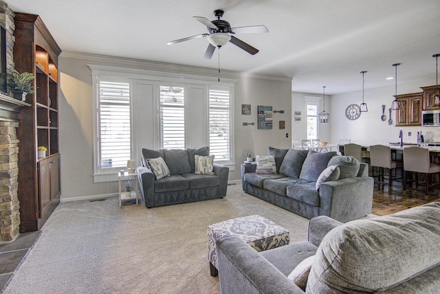 16324 S Locust St, Olathe, KS 66062 - living room with a ceiling fan, light carpet, and crown molding
