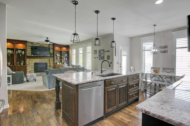 16324 S Locust St, Olathe, KS 66062 - kitchen featuring a ceiling fan, stainless steel dishwasher, plenty of natural light, and a fireplace