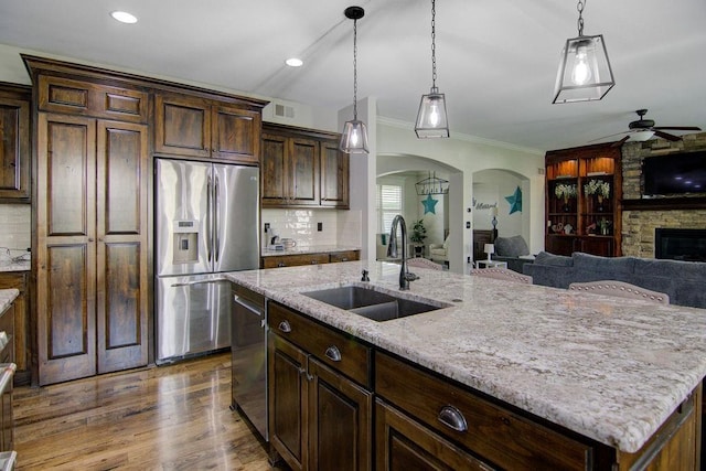 16324 S Locust St, Olathe, KS 66062 - kitchen featuring ceiling fan, appliances with stainless steel finishes, arched walkways, decorative light fixtures, and ornamental molding