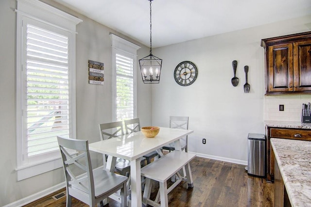 16324 S Locust St, Olathe, KS 66062 - dining room featuring a chandelier and dark wood-style flooring