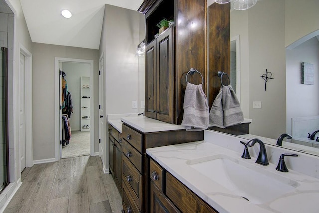 16324 S Locust St, Olathe, KS 66062 - full bathroom featuring wood finished floors, a spacious closet, vanity, and a stall shower