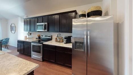 550 W Fountain St, Gardner, KS 66030 - kitchen featuring appliances with stainless steel finishes, light countertops, and light wood finished floors