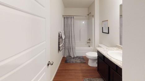 550 W Fountain St, Gardner, KS 66030 - bathroom with vanity, wood finished floors, and shower / tub combo with curtain