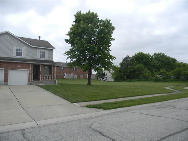 725 SE 10th St, Lees Summit, MO 64081 - view of front of house with a front lawn, driveway, brick siding, and an attached garage