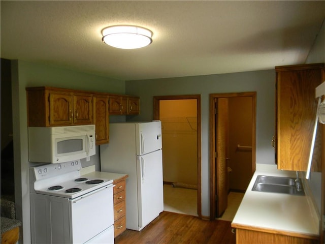 725 SE 10th St, Lees Summit, MO 64081 - kitchen with white appliances, dark wood-type flooring, brown cabinets, and light countertops