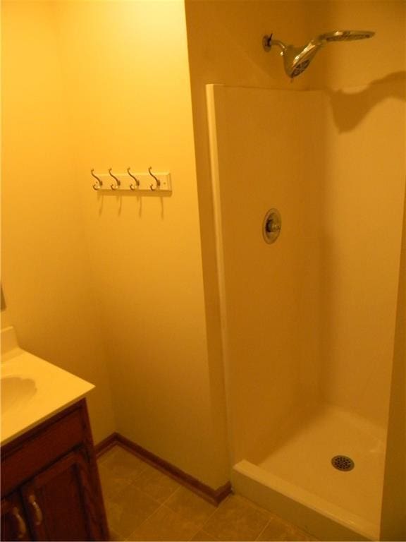 725 SE 10th St, Lees Summit, MO 64081 - bathroom with a shower stall, vanity, and tile patterned flooring