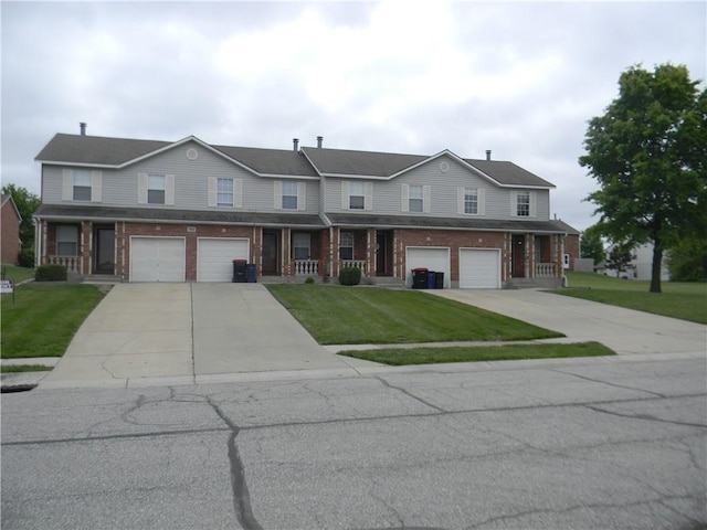 730 SE 10th St, Lees Summit, MO 64081 - traditional home with driveway, a garage, brick siding, and a front lawn