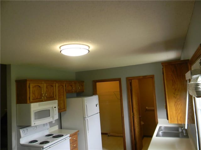 730 SE 10th St, Lees Summit, MO 64081 - kitchen featuring white appliances, brown cabinetry, and light countertops