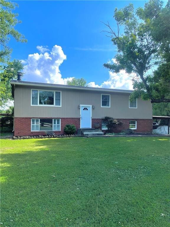 177 1150th St, Humboldt, KS 66748 - raised ranch with a front yard, brick siding, and a carport