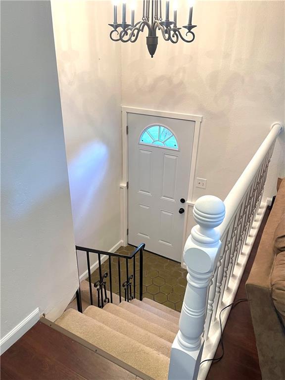 177 1150th St, Humboldt, KS 66748 - entryway featuring a chandelier, stairway, and dark wood-type flooring