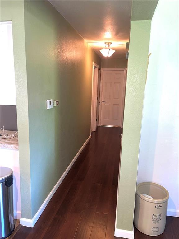 177 1150th St, Humboldt, KS 66748 - hall featuring dark wood-type flooring and baseboards