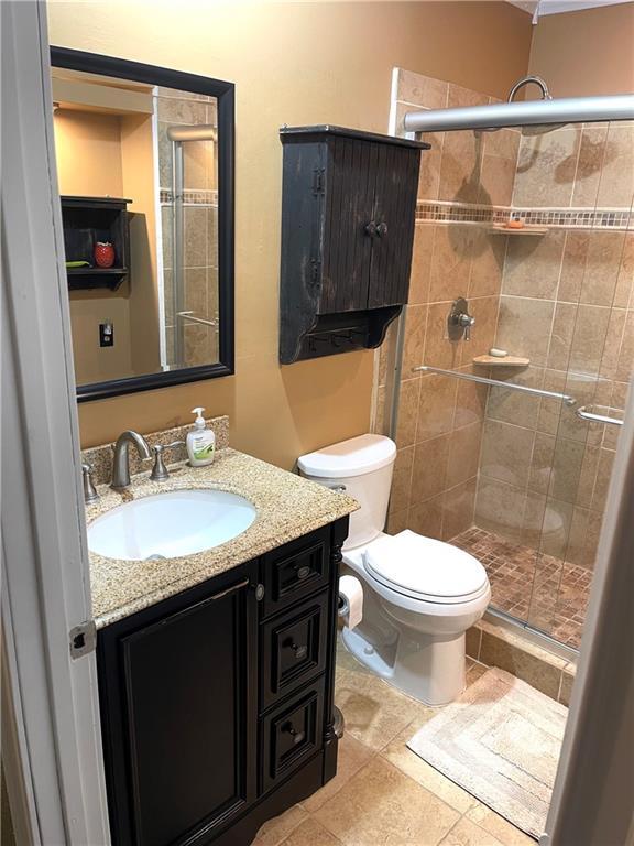 177 1150th St, Humboldt, KS 66748 - bathroom with vanity, a shower stall, and tile patterned flooring