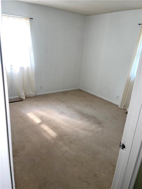 177 1150th St, Humboldt, KS 66748 - carpeted spare room with a textured ceiling and baseboards